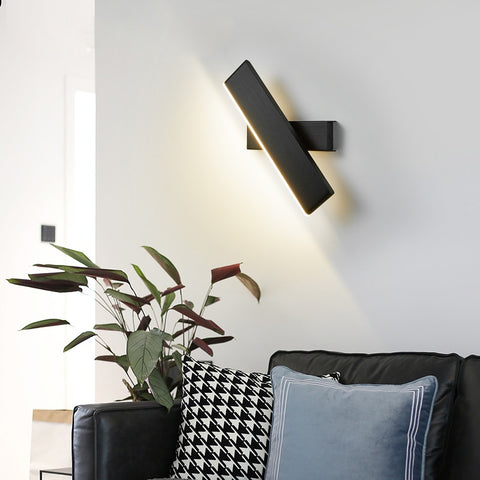 contemporary diagonal LED wall sconce over couch