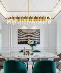 crystal tube chandelier with gold frame hanging in dining room