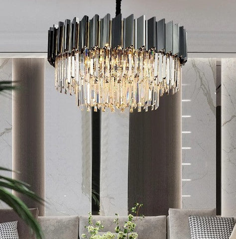 two tier crystal and gun metal grey chandelier hanging over sofa in gray living room