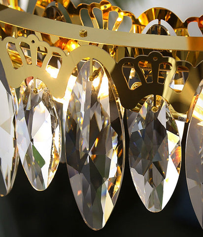 oval shaped crystals on oval chandelier with gold finish close up 
