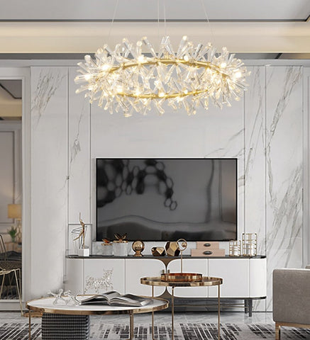 one tier crystal chandelier in front of marble feature wall