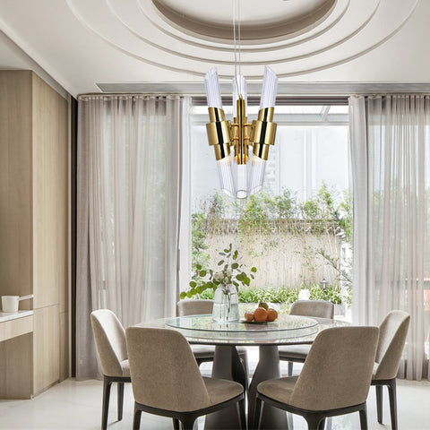 gold and glass chandelier hanging over dining room table
