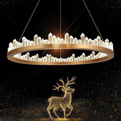 round gold chandelier with crystal obelisks hanging over ethereal golden star deer 