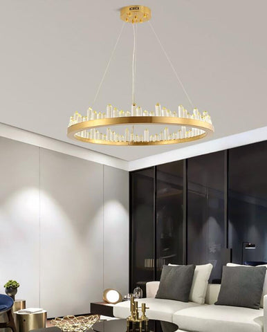 round gold chandelier with crystal obelisks over living room