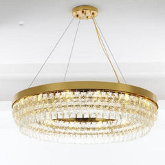 Circular Gold Chandelier with Clear Crystals and LED Bulbs.