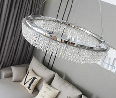 crystal round chandelier hanging over couch