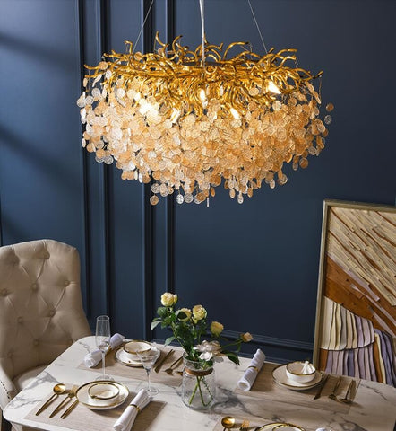 round gold branch style capiz shell chandelier illuminated over dining room table