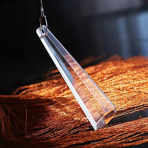 detail of precision cut crystal lit and suspended atop taddle