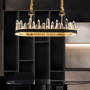 oval gold chandelier with leather bank and obelisk shaped crystals over glass table