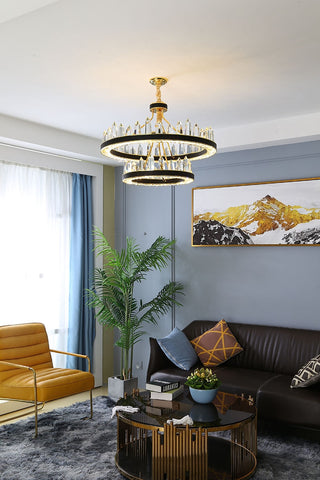 round crystal chandelier with leather and gold over living room