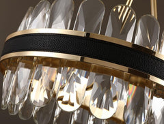 detail of leather and gold band around body of oval chandelier and crystals