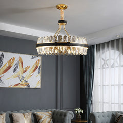 round crystal chandelier with leather and gold hanging in living room