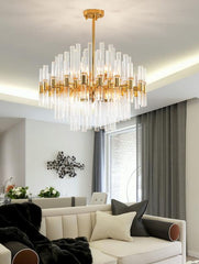 gold body chandelier with crystal tubes hanging in chic living room