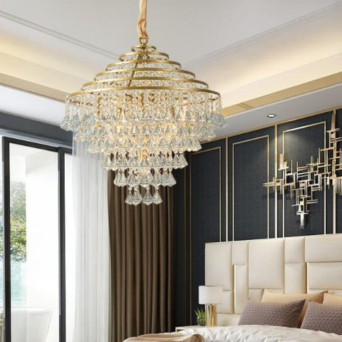 crystal and gold conical chandelier illuminated in bedroom
