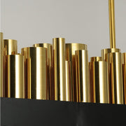 gold cylinders atop chandelier in varying sizes