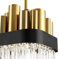detail of gold cylinders atop chandelier, black body, and crystal on bottom 