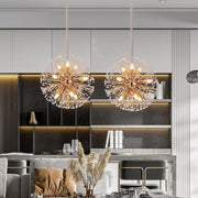 two gold dandelion crystal chandeliers over kitchen island