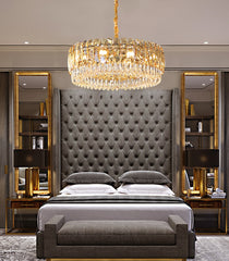 round champagne crystal chandelier hanging over gray master bedroom set