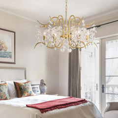 gold and crystal chandelier over bed