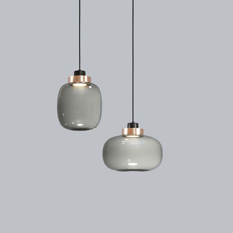 two glass minimalist lights with copper base with cord suspension