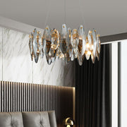 round crystal chandelier tinted and clear illuminated in bedroom