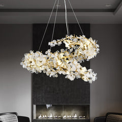 frosted shell gold branch chandelier hanging in front of fire place