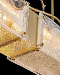 close up of rectangular glass chandelier with cloud texture and copper branch on top