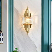 art deco style crystal and copper wall sconce hanging on marble wall