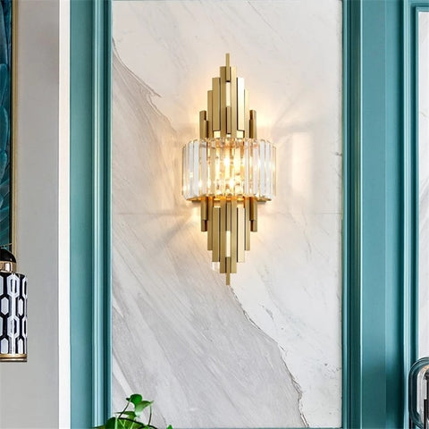 art deco style crystal and copper wall sconce hanging on marble wall