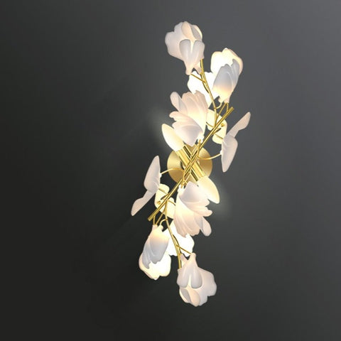 gold stem wall sconce with white ceramic flowers