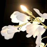 gold stem wall sconce with white ceramic flowers close up detail 