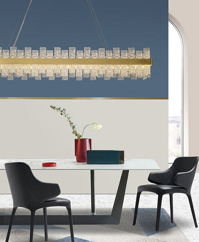 long rectangular water pattern glass chandelier with gold band hanging in contemporary dining area