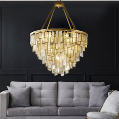 Round Copper Gold Art Deco Post Modern Glass chandelier hanging over gray sofa