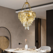 Round Copper Gold Art Deco Post Modern Glass chandelier hanging over contemporary dining table