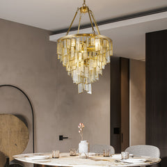 Round Copper Gold Art Deco Post Modern Glass chandelier hanging over contemporary dining table