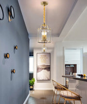 gold finish nordic lantern style glass pendant hanging in pair in hallway