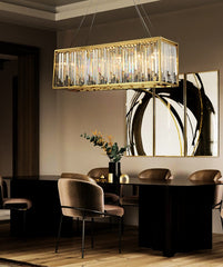 rectangular crystal chandelier with gold frame in modern style hanging over a dining table