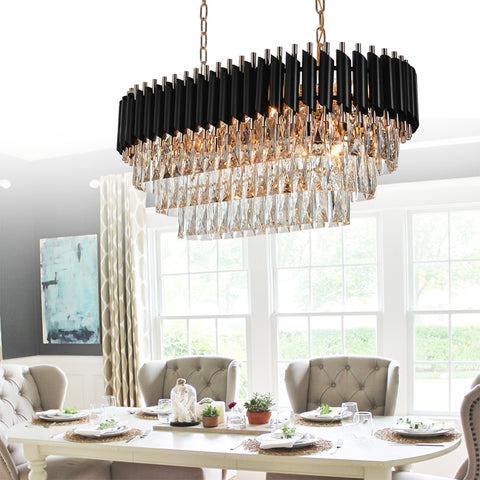 oval shaped multi tier crystal chandelier with black top hanging in dining room